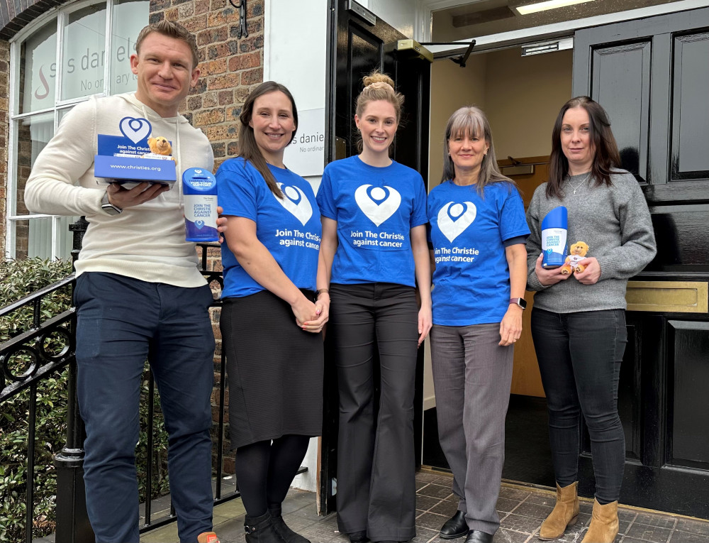 Five of the skydivers pose outside the steps of their Congleton office. (Image - SAS Daniels) 