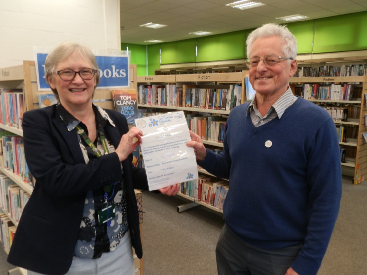 Dave Whitworth, Chair of Dementia Friendly Sandbach presents Sandbach library manager, Rowena Gomersall, with the certificate. 