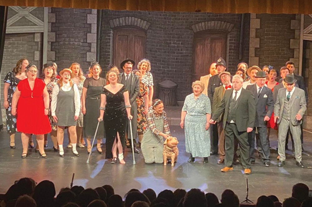 The cast, including the indomitable Mary Bloss, take their well-deserved curtain call. 