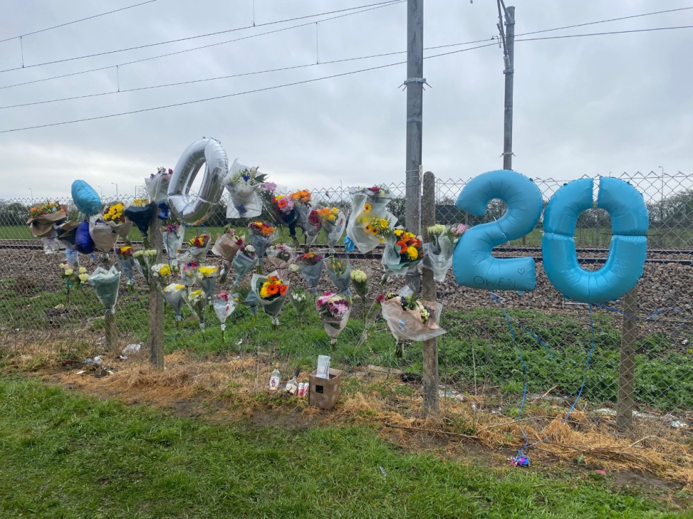 Many symbolic items have been placed beside the track. 