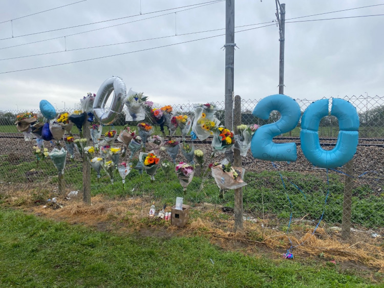 Many symbolic items have been placed beside the track. 