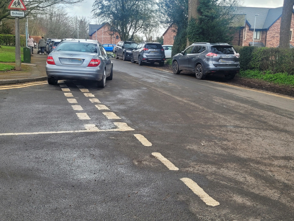 Cars are parked dangerously and block driveways outside St Johns CE Primary School (LDR).