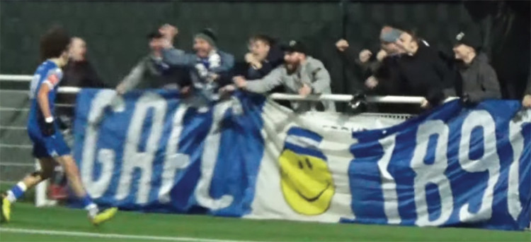 Troy Osi-Bobie celebrates his goal with the Grays fans.