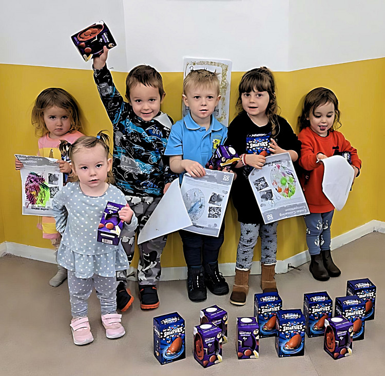 Children at Honeybees playgroup with their drawings and prizes