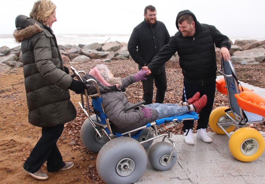 Residents try out the new West Bay beach wheelchairs at the launch event on Friday (photo credit: Sara Phillips)