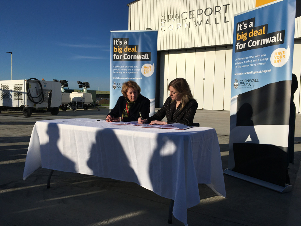 Cornwall Council leader Linda Taylor and Levelling Up minister Dehanna Davison sign the Cornwall Devolution deal at Spaceport Cornwall (Image: Richard Whitehouse LDR)