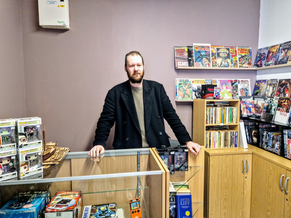 Gumshoe Comics & Collectibles, Crewe Market Hall, is owned by Peter Bruder (Ryan Parker). 