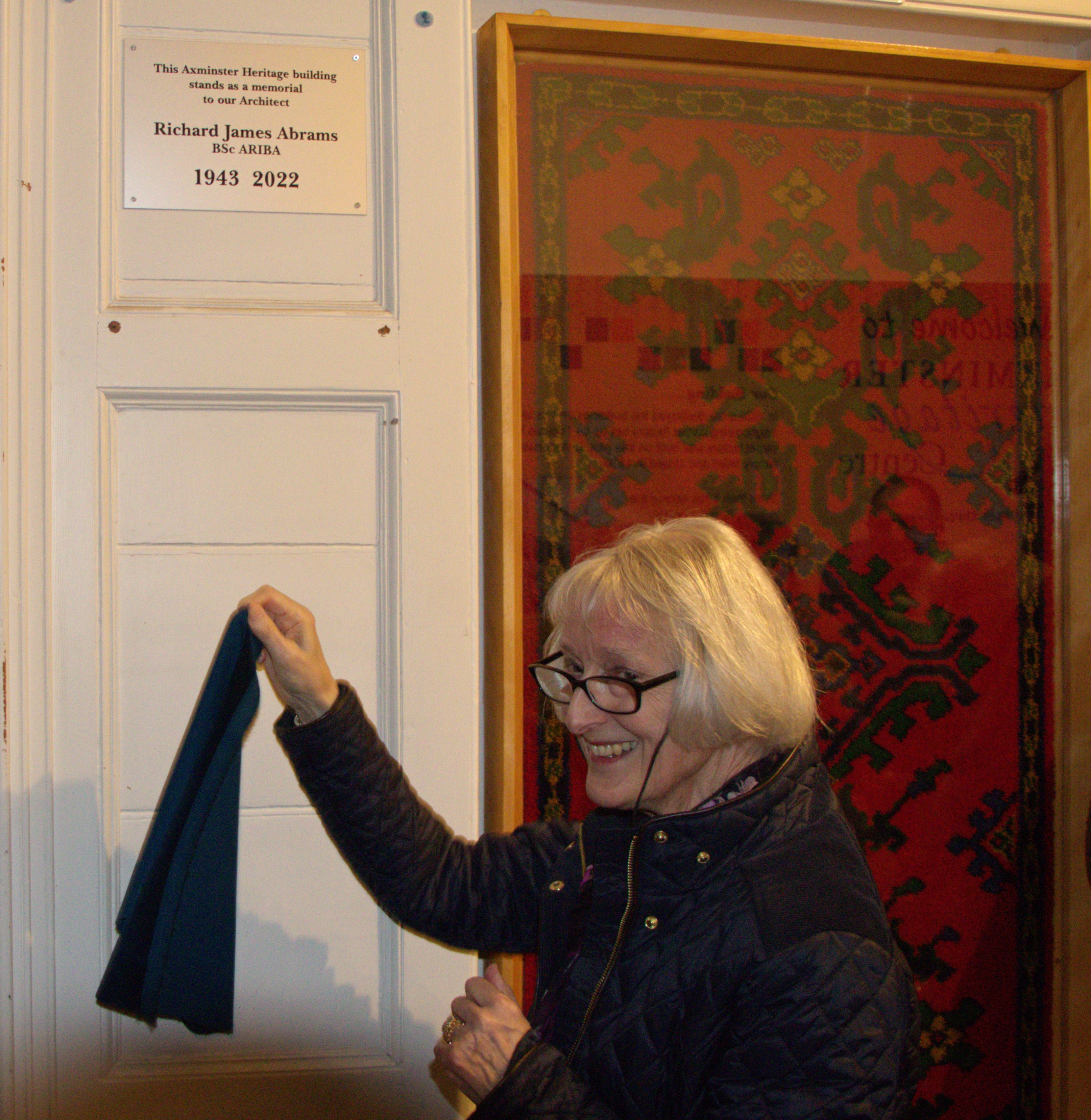 Richard Abrams' widow, Hilary Abrams, unveils her late husband's plaque at Axminster Heritage Centre