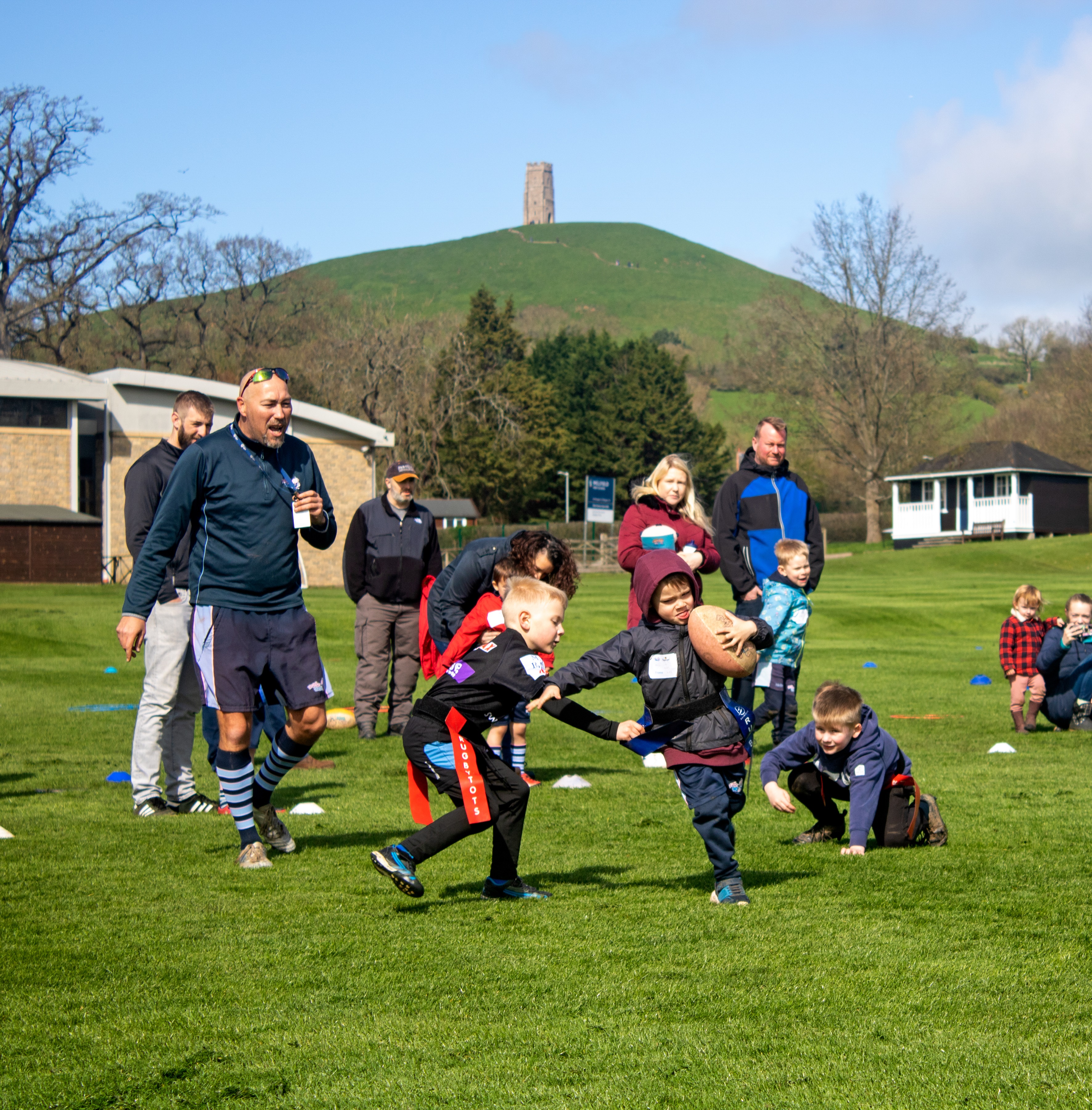 Rugbytots play at the foot of the Glastonbury Tor