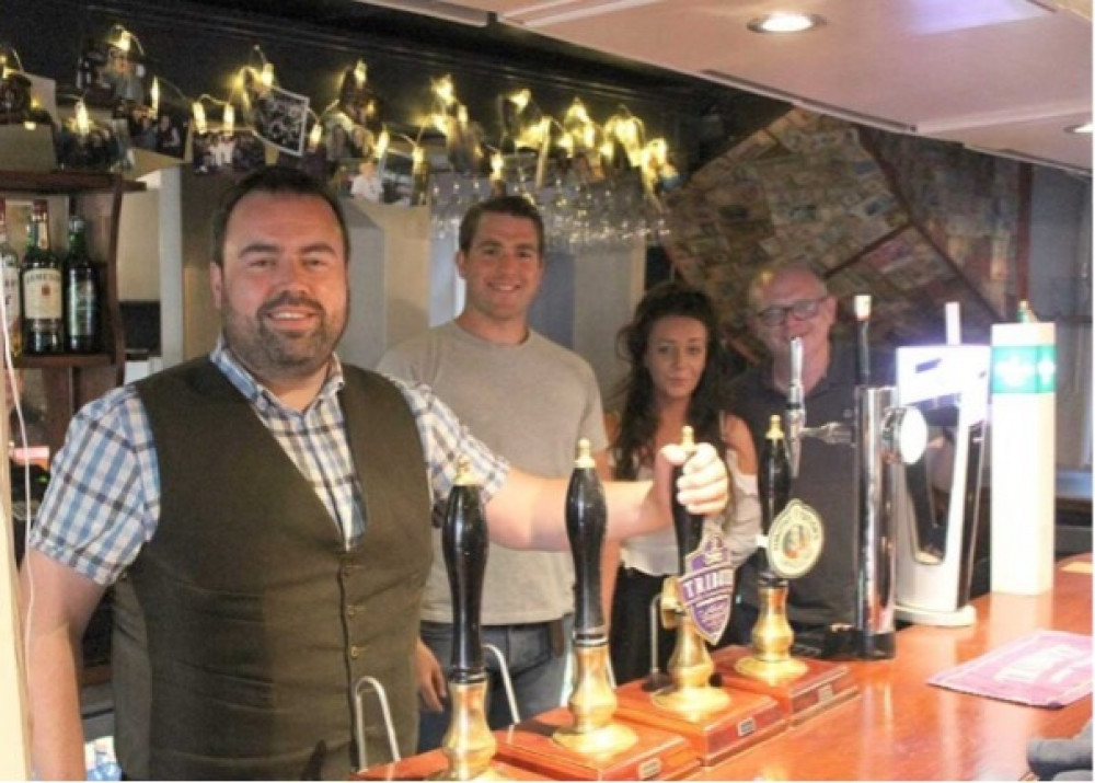 Local MP Chris Loder pictured behind the bar in a West Dorset pub