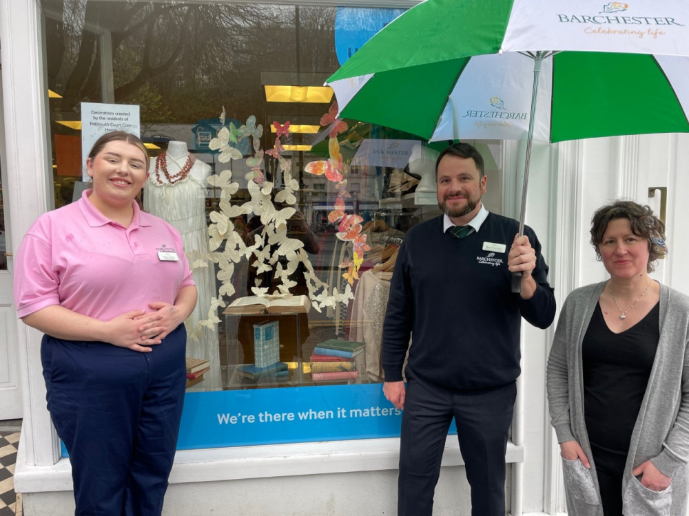 Sue Ryder staff and the care home staff gather outside the display (Image: Falmouth Court) 