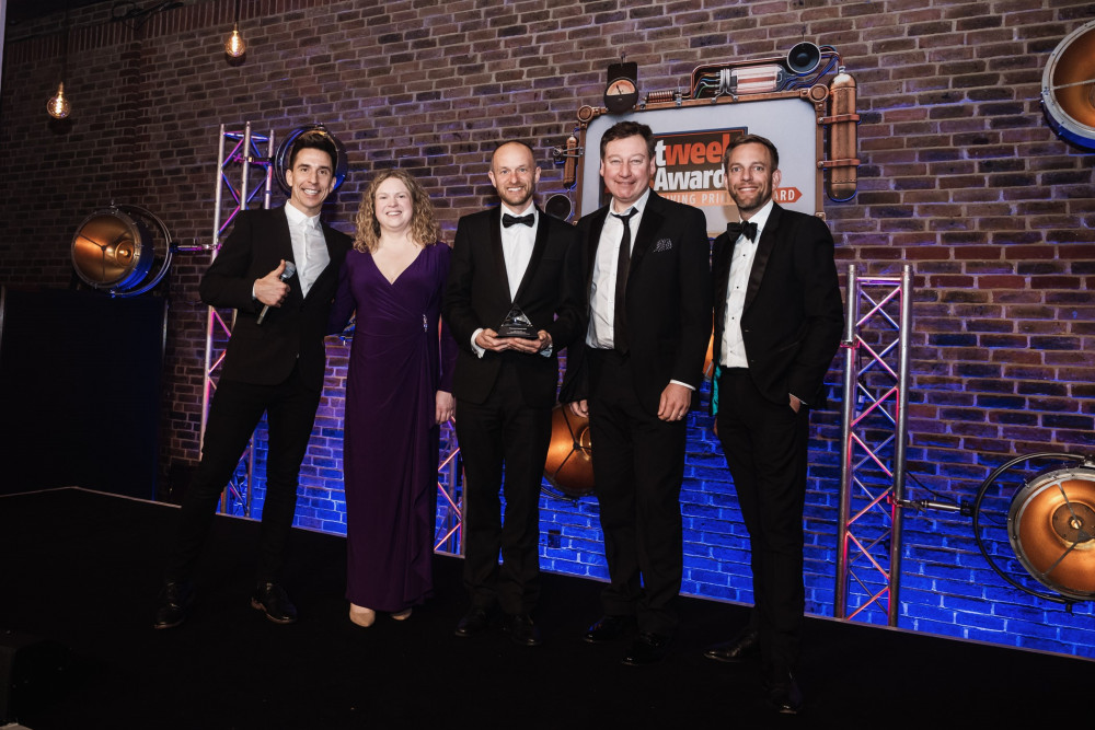PCS representatives picking up the award at the awards gala from comedian, Russell Kane - middle three from left to right: Louise Ray, director of marketing & communications, Adam Unsworth, managing director, Paul Hansford, sales director (Image - PCS)
