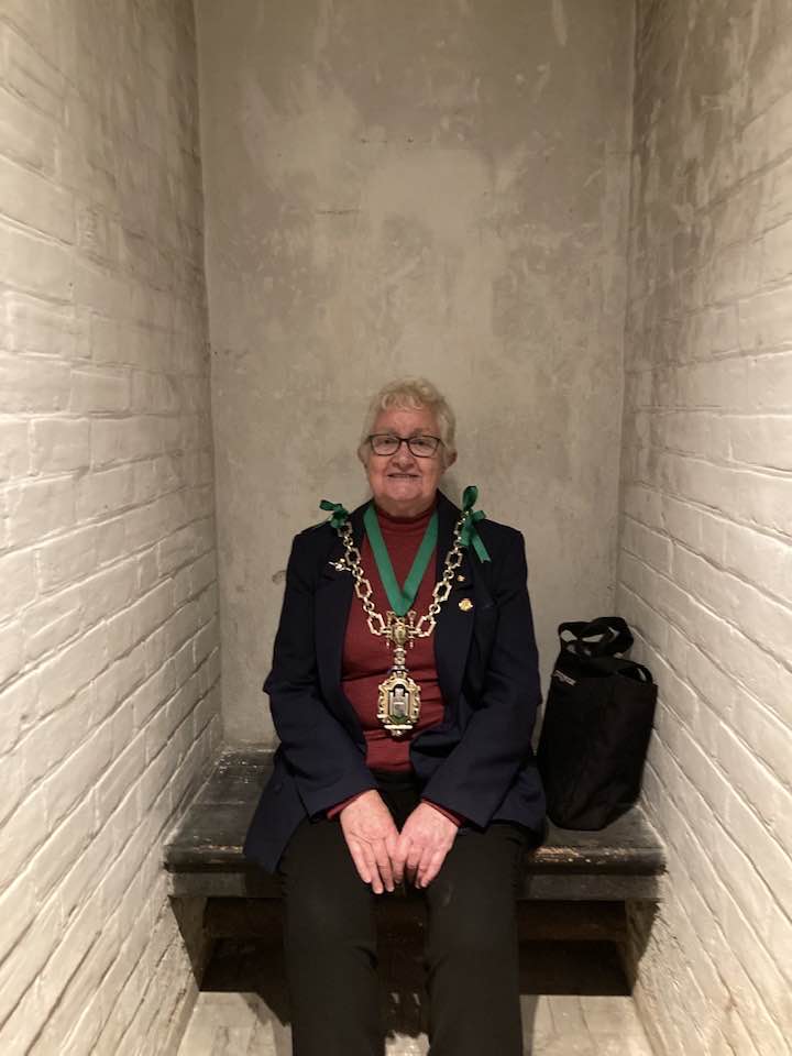 The Mayor of Dorchester, Cllr Janet Hewitt, tries out one of the cells at Shire Hall Museum (photo credit: Discover Dorchester/Dorchester Town Council)