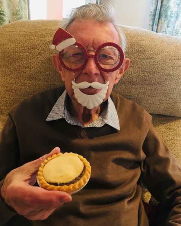 A local senior citizen receiving his mince pie from the Devonshire Bakery as part of Home Instead's Santa to a Senior campaign