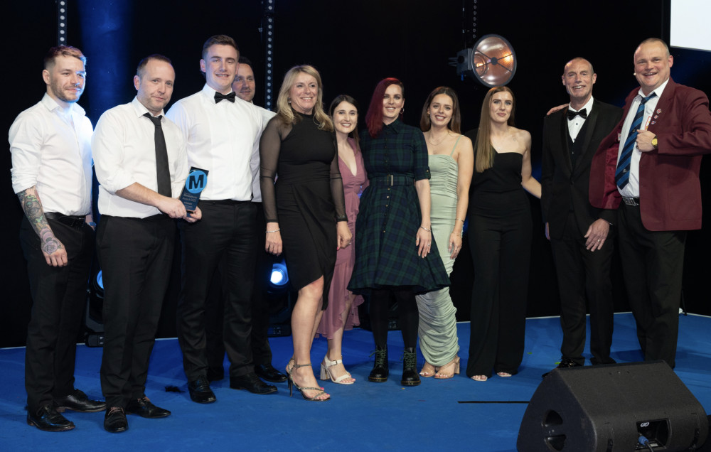 Letchworth based bank Redwood makes it five out of five at industry awards. PICTURE: Staff receive the accolade alongside the Pub Landlord Al Murray. CREDIT: Strand PR