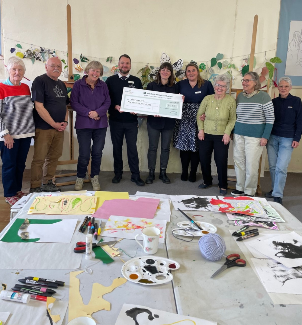 Care home staff present the charity with the cheque at one of their art sessions (Image: Falmouth Court Care Home) 