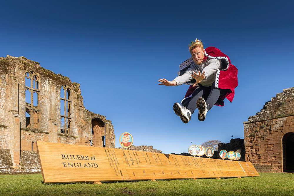 Retired Olympic long jump champion Greg Rutherford jumps along the new ruler of rulers (image via English Heritage)