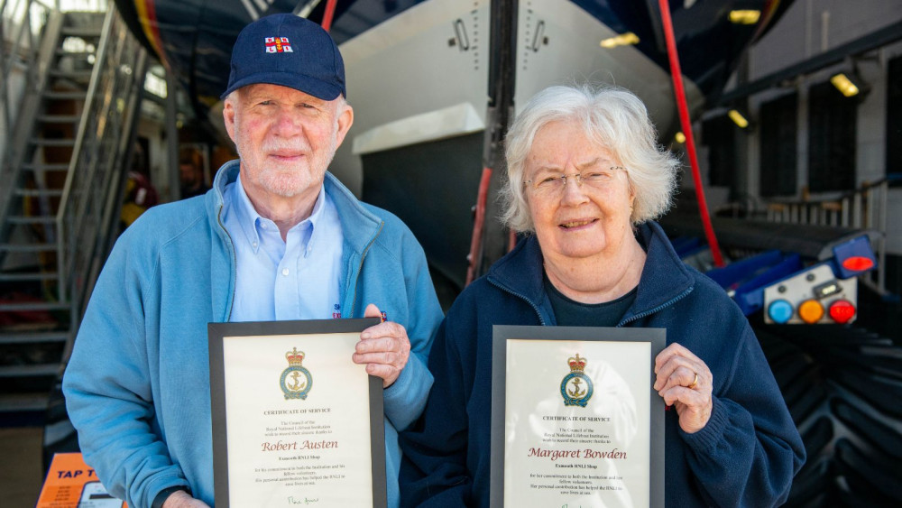 Robert Austen and Margaret Bowden with their certificates at Exmouth Lifeboat Station (John Thorogood/ RNLI)