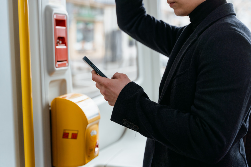 East Midlands Railway (EMR) is reminding customers using digital e-tickets on their services to ensure they always have sufficient battery power to present their ticket and electronic railcard for inspection – or they will be liable for a £100 penalty fare. Photo by MART  PRODUCTION (https://www.pexels.com/photo/person-using-a-smartphone-while-riding-a-train-7251087/)