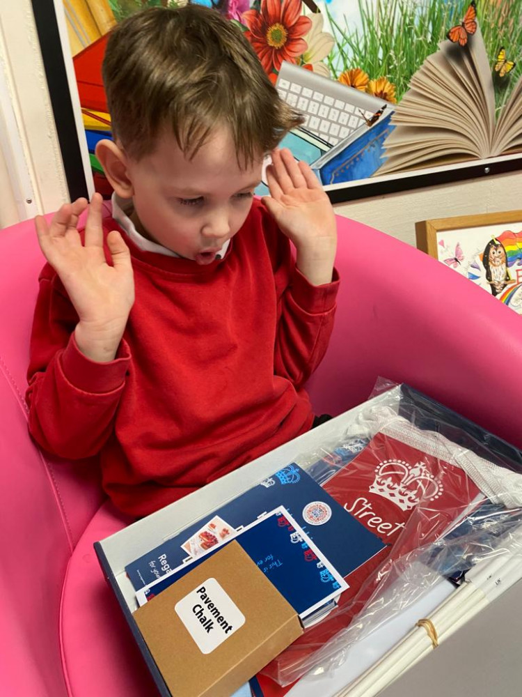 Excited six-year-old James Burt opens the party pack ready for his school's Coronation picnic celebration. (Photo: Tarrin Weigelt) 