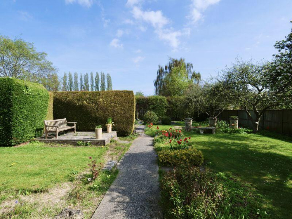 A paved patio to the rear offers a secluded seating area. There is access to the workshop behind the garage. A paved patio to the rear offers a secluded seating area. There is access to the workshop behind the garage.