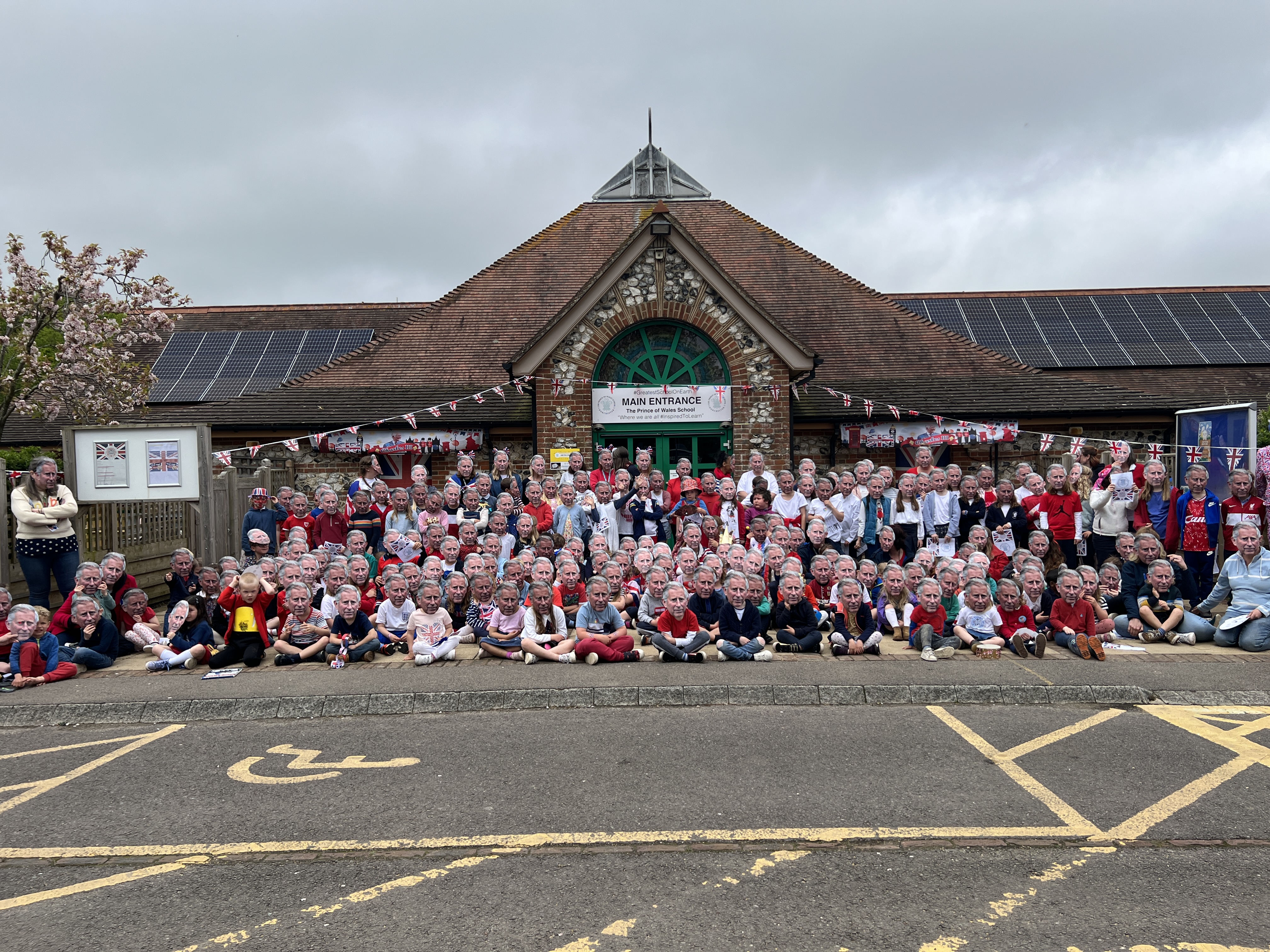 Staff and pupils at the Prince of Wales School wear King Charles masks (photo credit: Prince of Wales School)