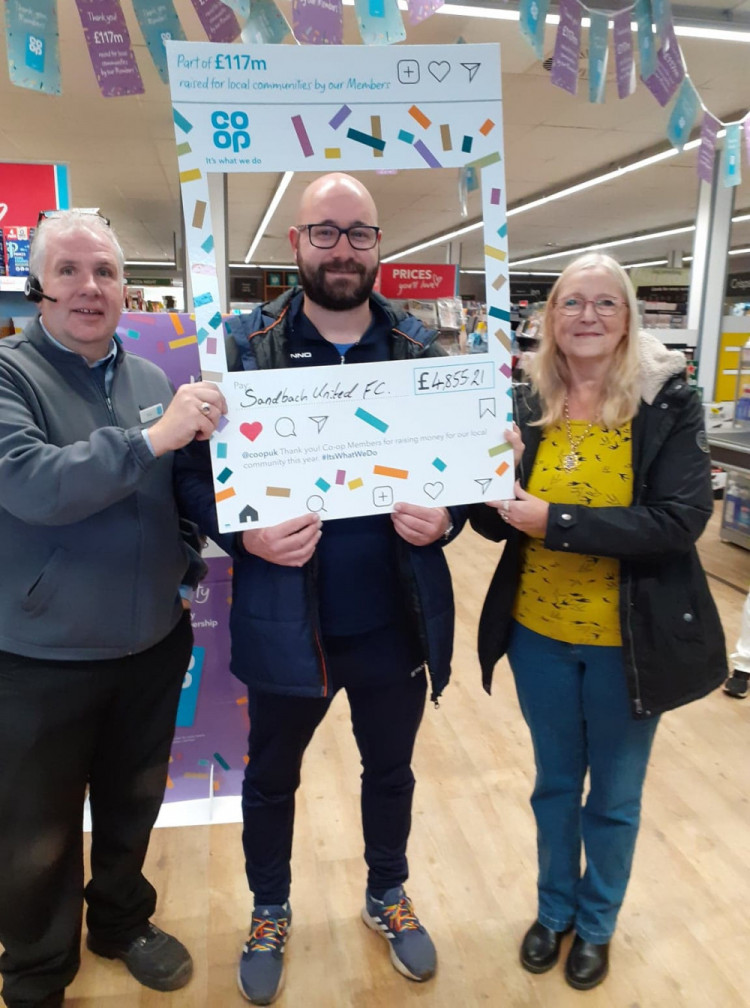 Sandbach United's Oliver Byron (middle) with Nick James, manager, Co-op Lawton Way and Sandbach Mayor, Councillor Kathryn Flavell on pay-out day.  