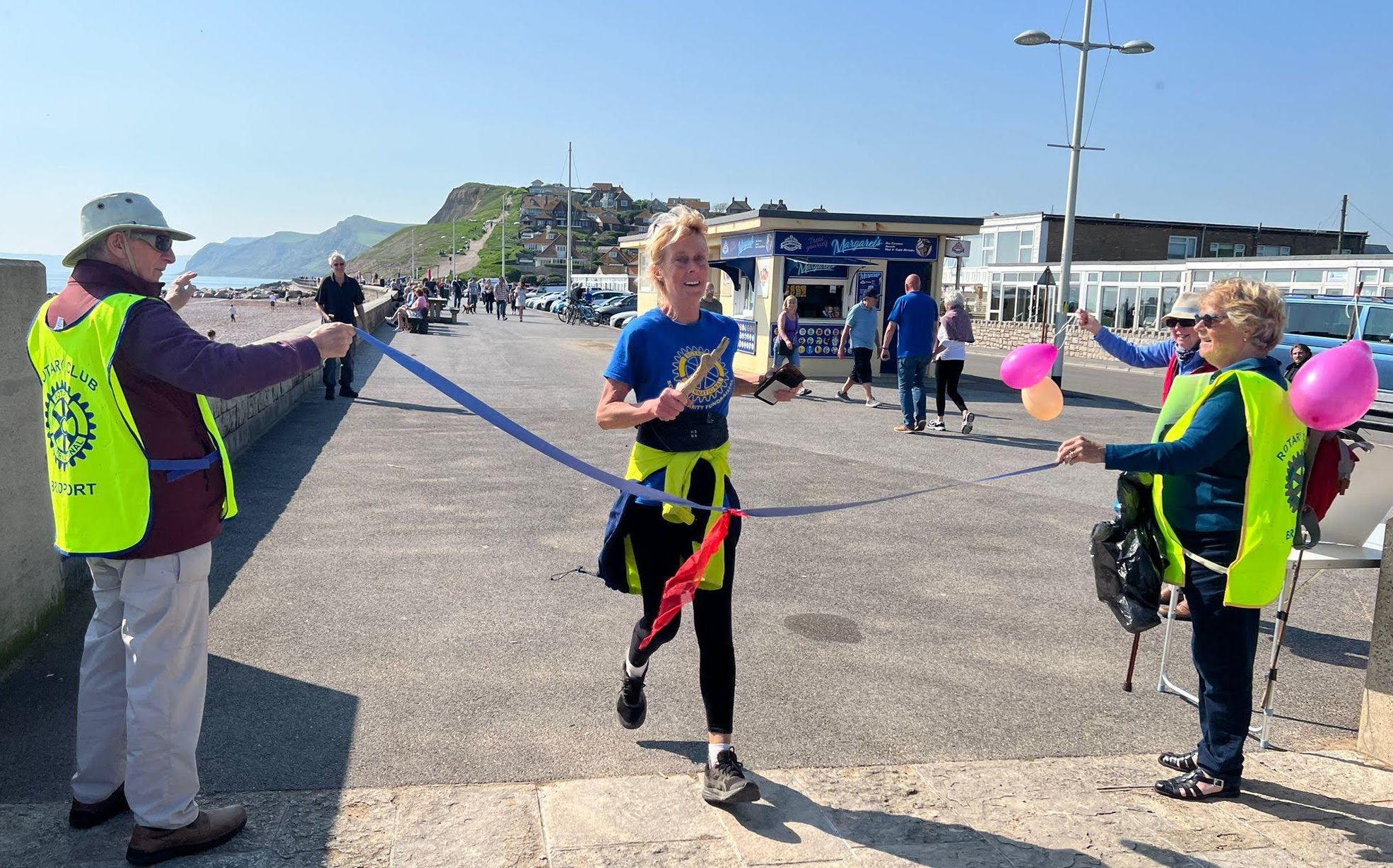 Rachel Goodfellow, president of the Rotary Club of Sherborne Castles, completes her 38th marathon in 38 days at West Bay