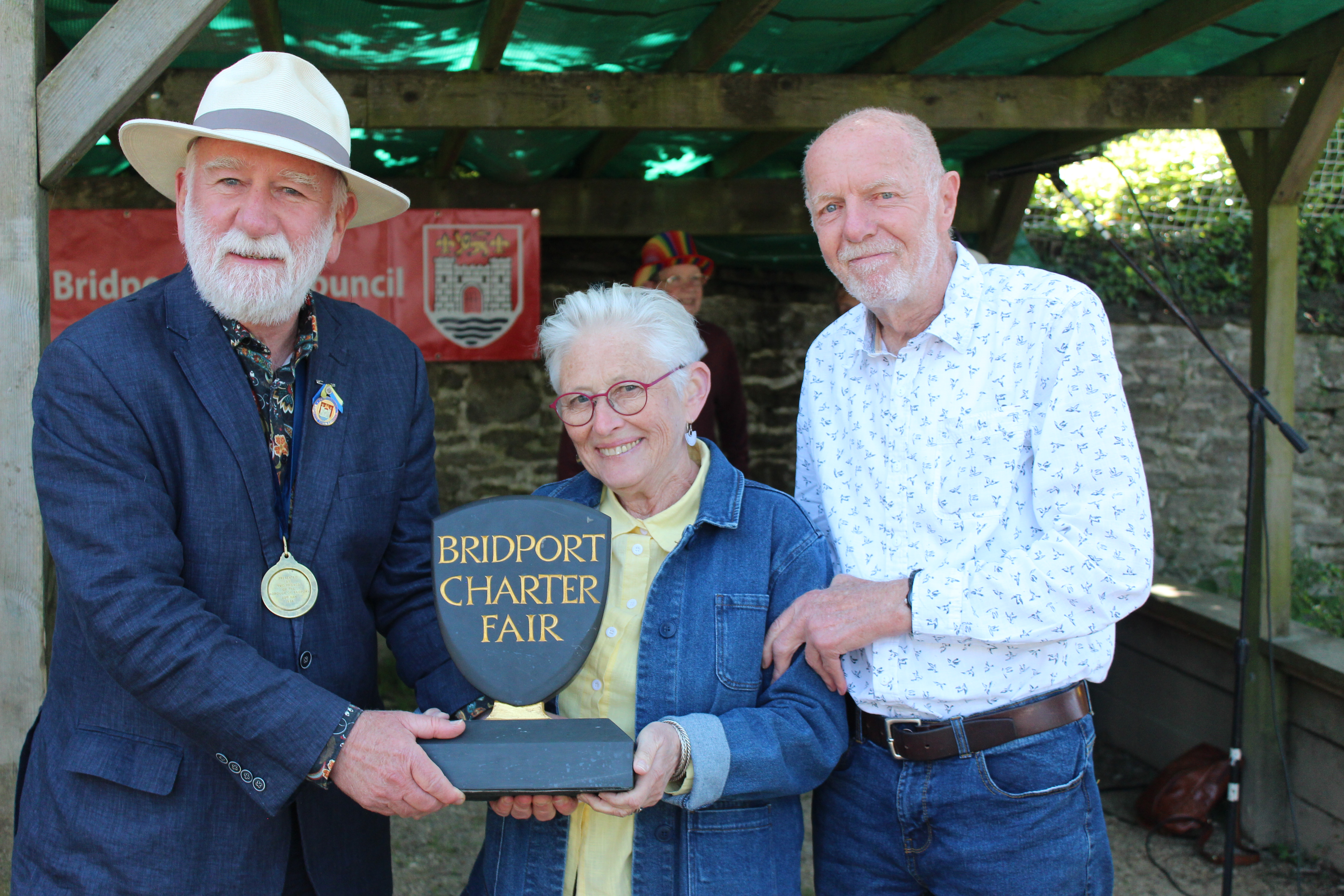 Cllr Ian Bark presents the Bridport Charter Fair Award to Jim and Jenny Tigg for their support for refugees