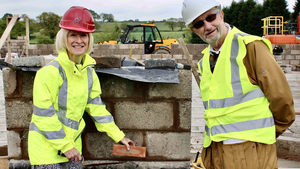 Allison Thomas, Chief Executive of North West Leicestershire District Council, with Roy Stobbs, Hospice Hope Trustee and lead on the build of Bright Hope House – laying  the first brick