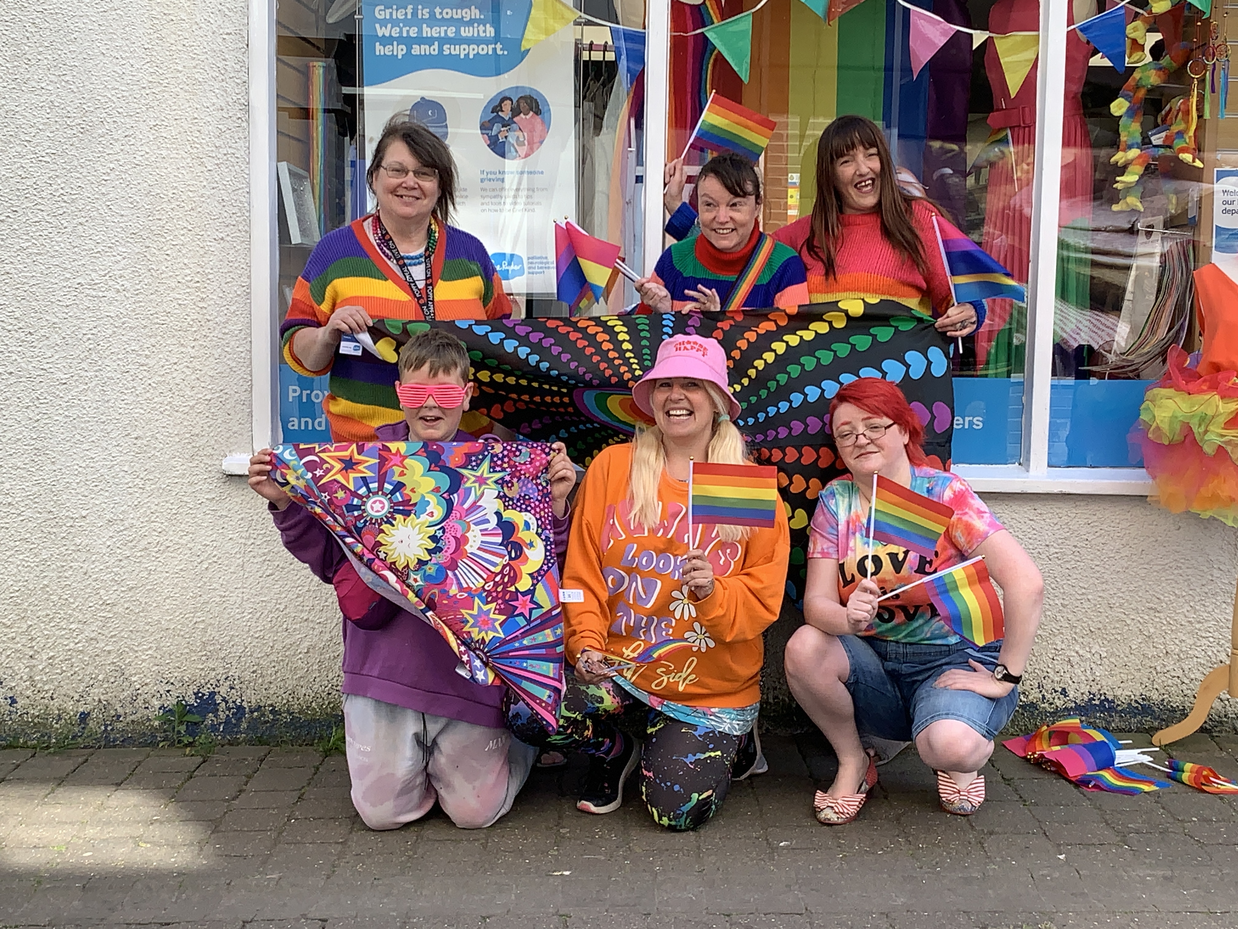 Staff and Customers of Shepton Mallet Sue Ryder Shop, wear rainbow clothes and fly Pride flags