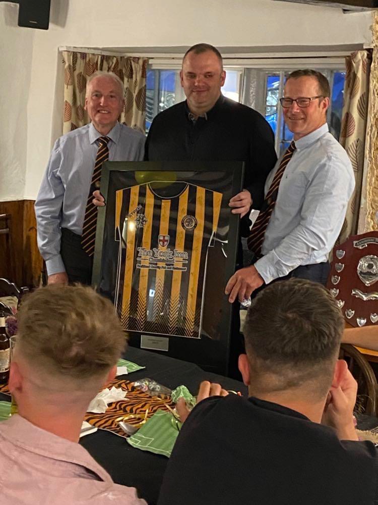 Manager Dan Prettejohn receives a framed shirt from chairman Andy Hurford