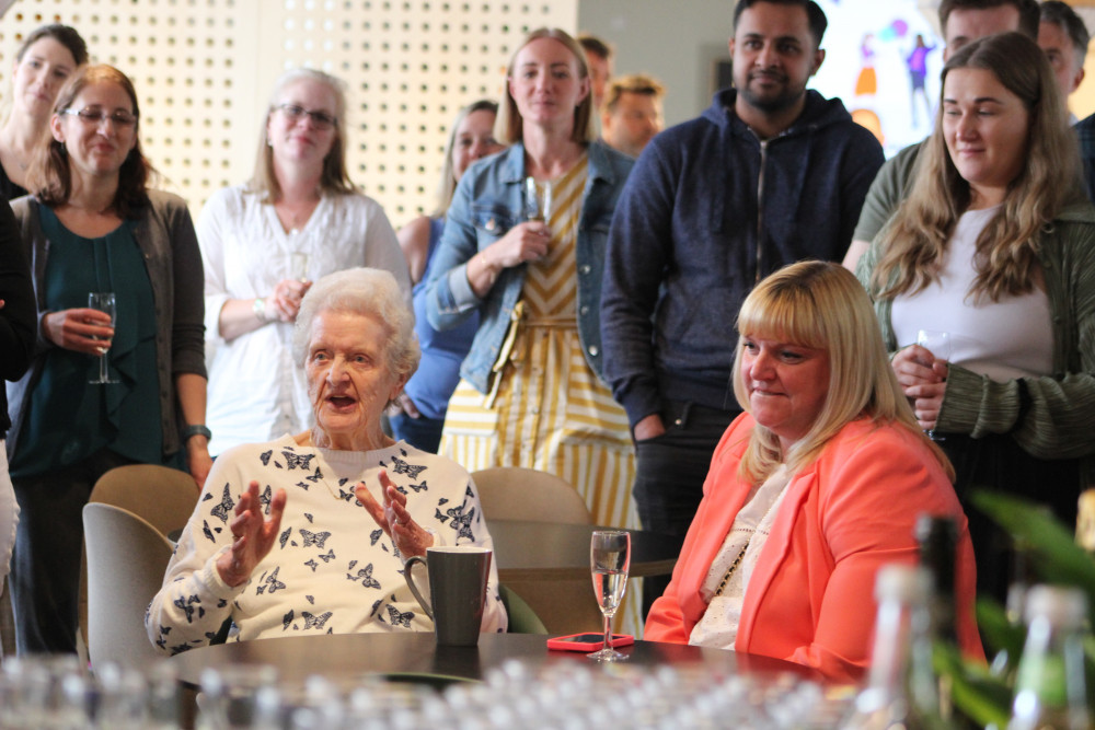 Joan Hulme, who used to work in Victoria Mill and was later promoted at another nearby Mill, was guest of honour to cut the ribbon for Inizio Medical's office relaunch in Macclesfield. (Image - Alexander Greensmith / Macclesfield Nub News) 