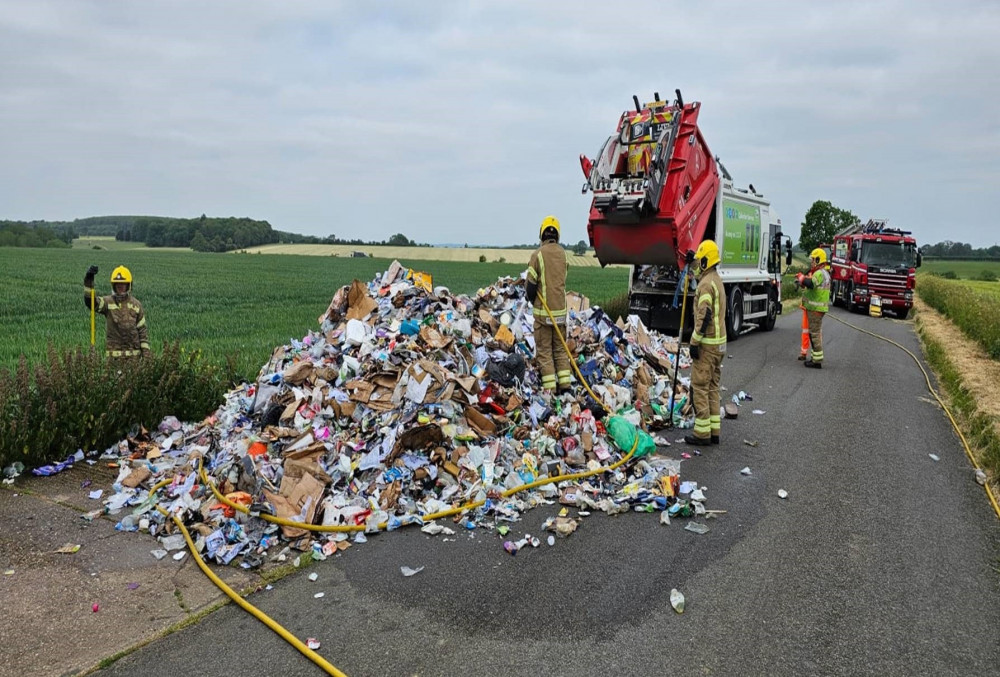 Crews had to empty the lorry onto the road and extinguish the contents (image via Stratford-on-Avon District Council)