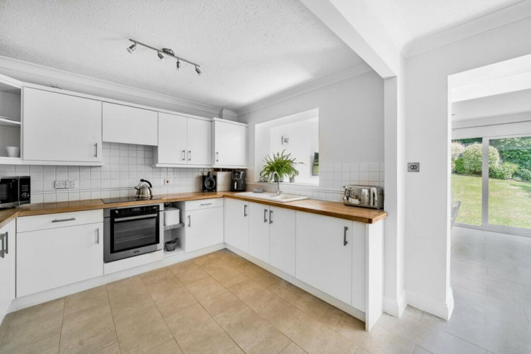 The modern kitchen and dining area looking out to the gardens