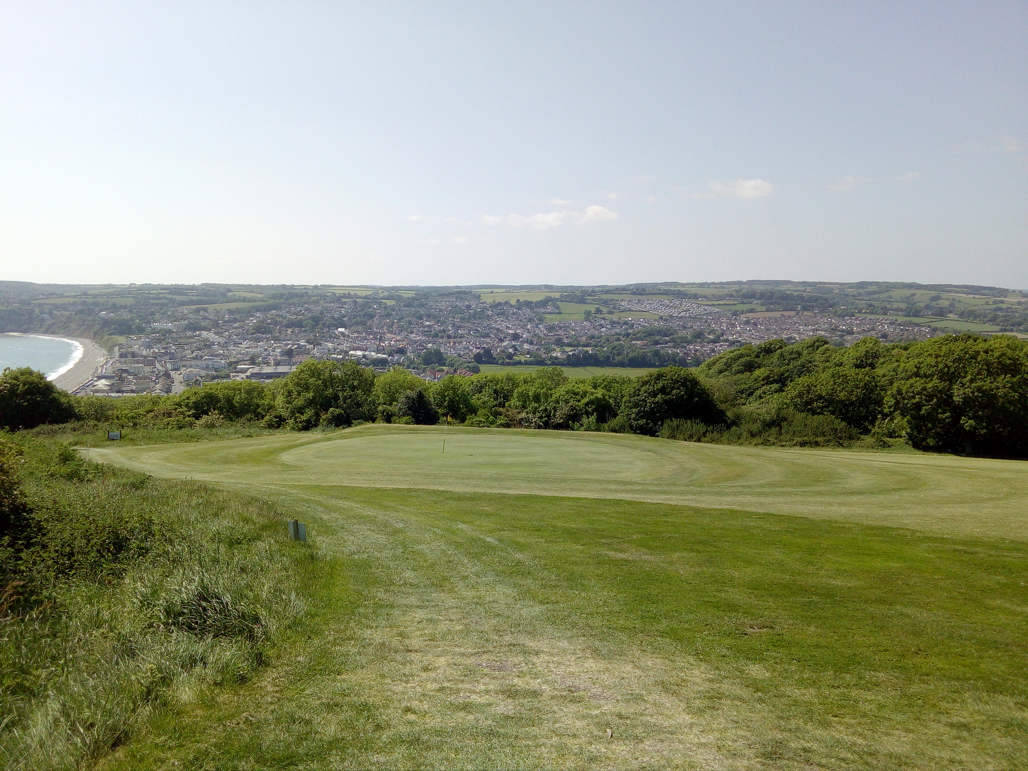 Axe Cliff Golf Club from hole 9 with Seaton and Lyme Bay in background