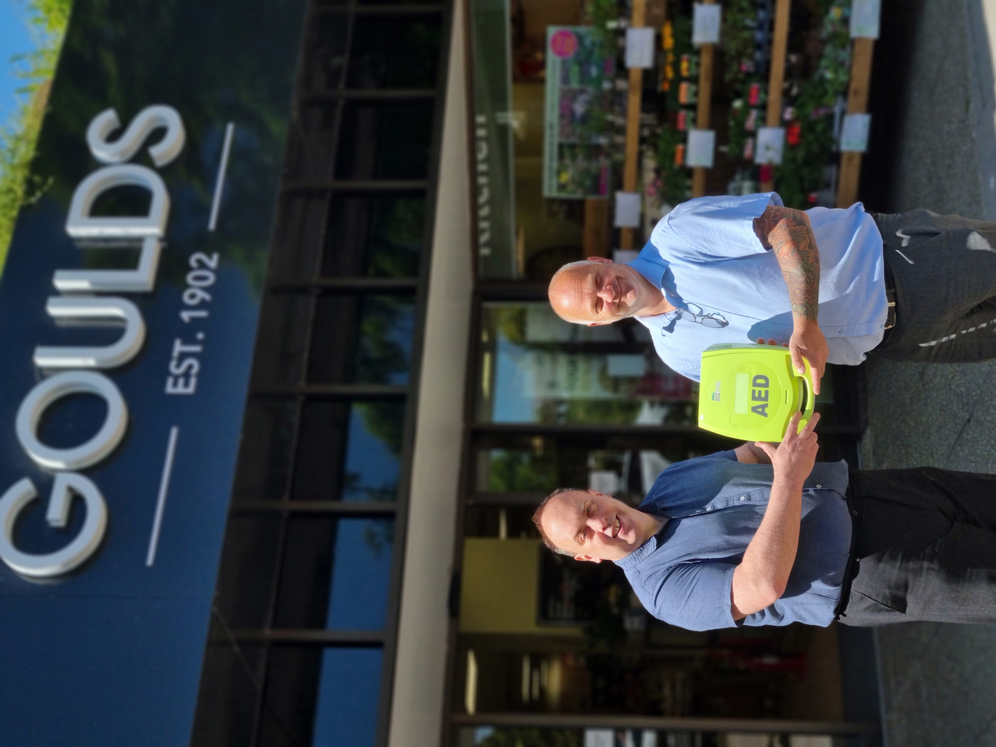 Dorchester BID chairman Neil Strudwick, of Goldcrest Jewellers, presents Nick Rawlings of Goulds Household store with their new Zol Defibrillator