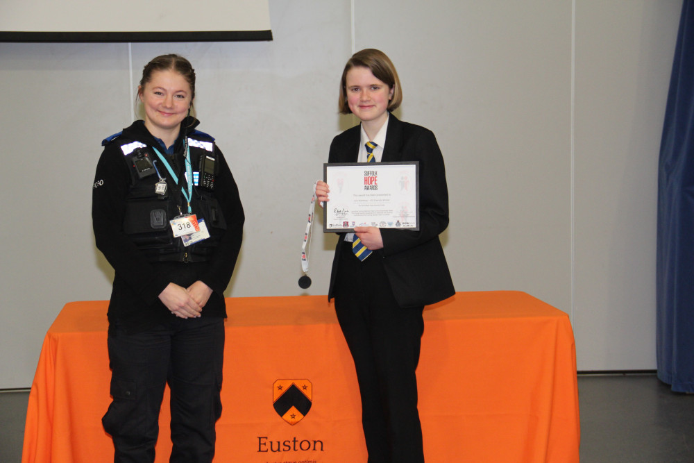 Felixstowe student Evie Matthews receives her HOPE award from police officer (Picture: Suffolk police)