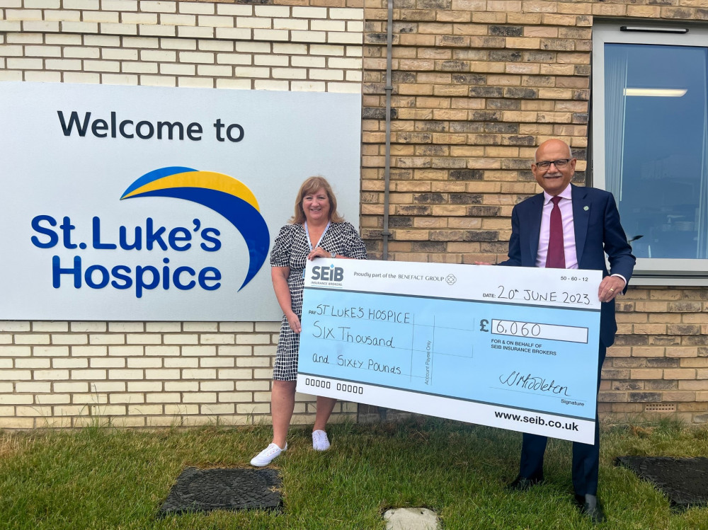 Bipin Thaker presents the cheque for £6,060 to Jackie Ross of St Luke's Hospice.