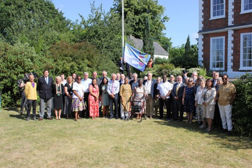 Members of the Celebrating Windrush in Devon group and Devon County Council members and officer raised the Windrush flag at County Hall in Exeter
