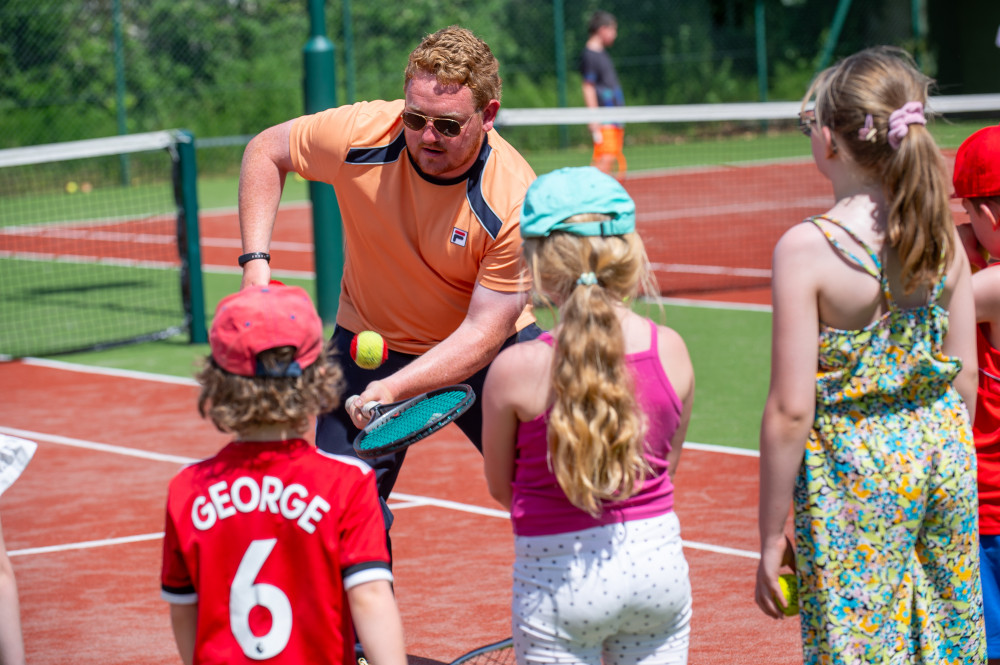 Club coach Chris Hancock giving some tips to the children. (Photo: Alsager Tennis Club) 