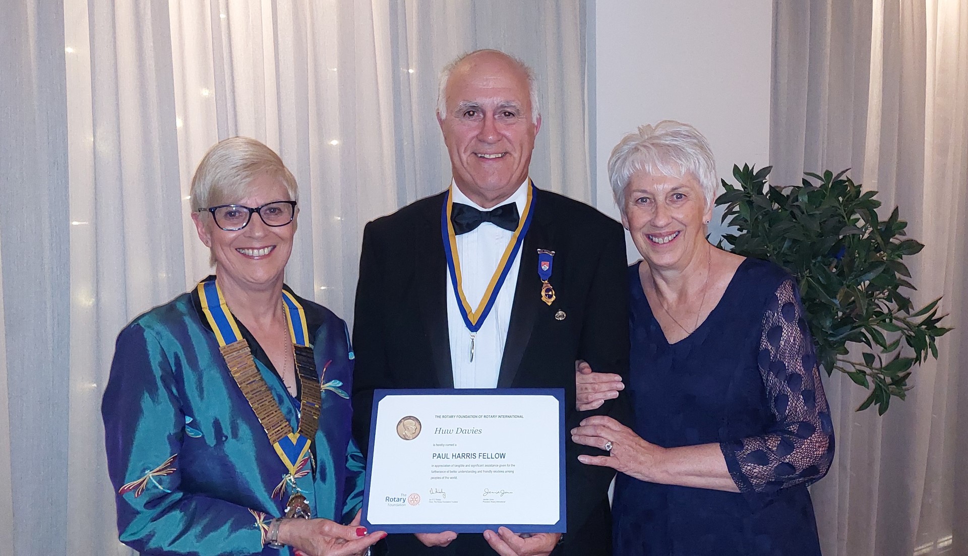 Carol Hallewell, Huw Davies and his wife Felicity with the Paul Harris Fellowship certificate.