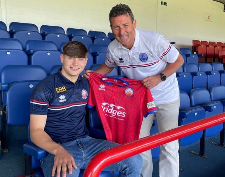 Shotley's Josh Stokes presented with shirt by Aldershot Town manager Tommy Widdrington (Picture contributed)