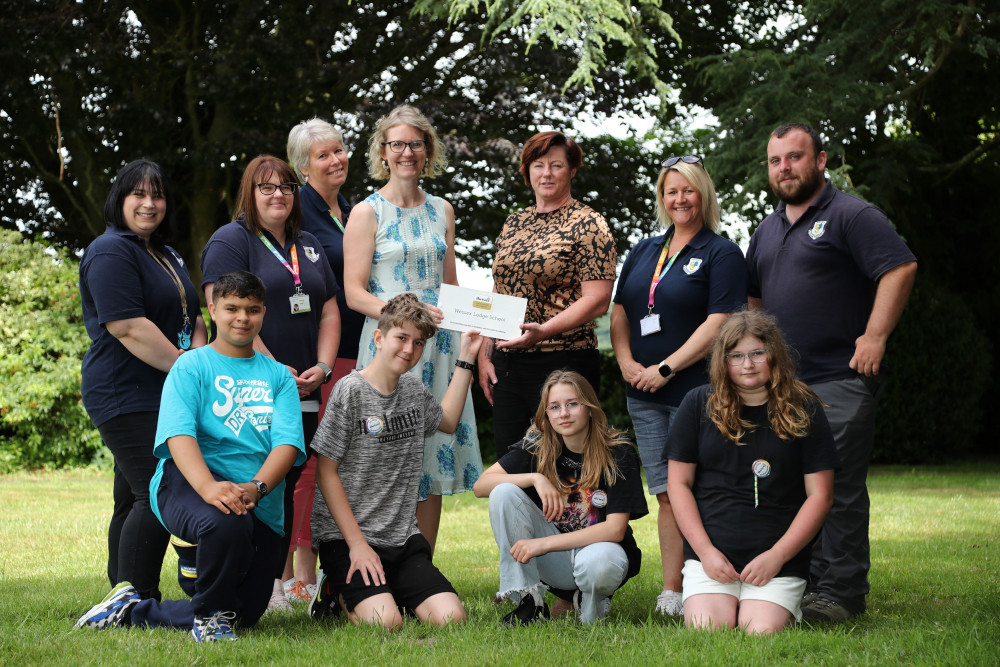 Photo shows L-R Dominique Le Brun, Rebecca Miller, Lizzie Bijok, all staff members at Wessex Lodge, Anna Smee, managing director of Thrive, Kate Stradling headteacher at Wessex Lodge, Katrina Critten and Sean Feeney, both staff members at Wessex Lodge. Front row are students from Wessex Lodge.