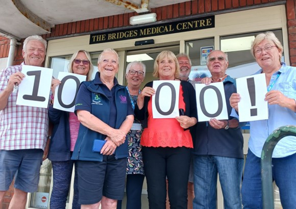 The digital volunteers in Weymouth and Portland celebrating supporting their 100th customer