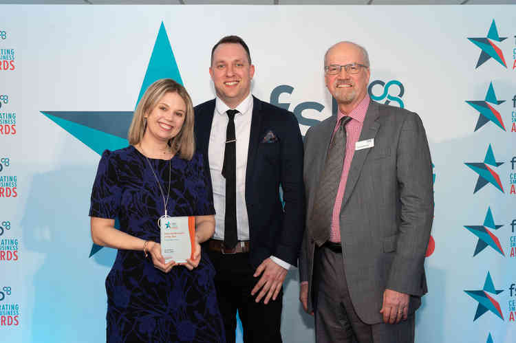 Laura Filer and Tom Lamb from Cheddar's Ocean Adventurers receive their first ever award, from Terry Lockwood, a South West-based director of the FSB