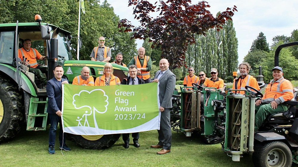 Councillor Michael Wyatt, Deputy Leader and Portfolio Holder for Community Services at NWLDC (left of picture, holding flag) congratulates the council’s parks team on their Green Flag achievements