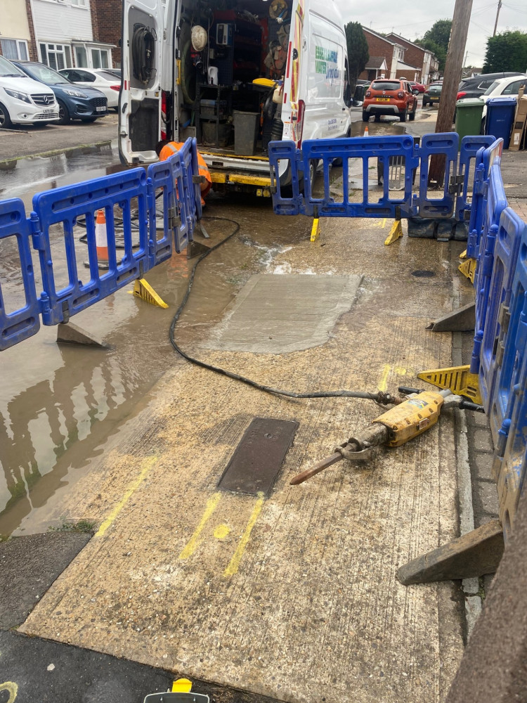 Water gushing up in Gideons Way. 