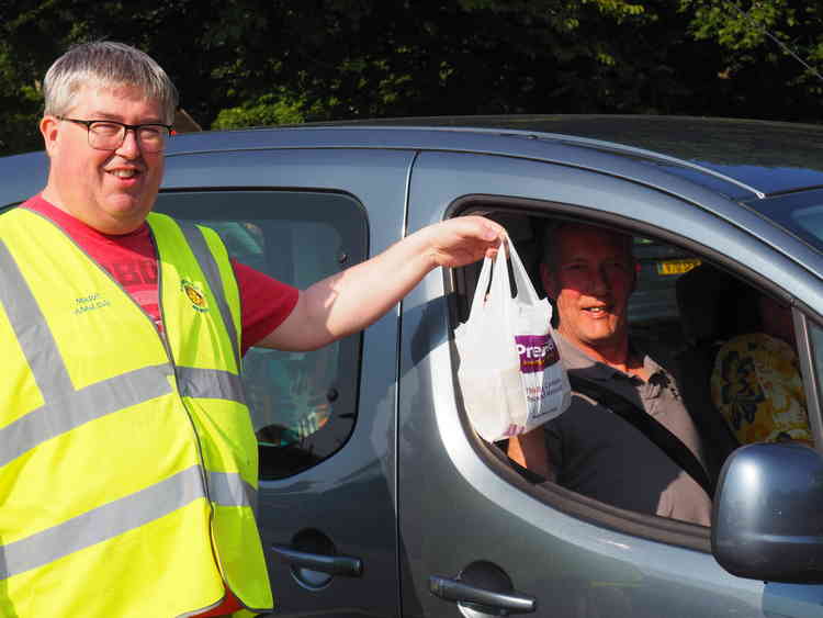 Mendip Rotarians hand out meals prepared by Anwar Hussain, one of their members