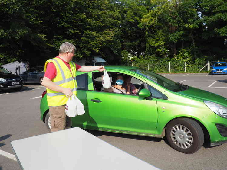 Mendip Rotarians hand out meals prepared by Anwar Hussain, one of their members